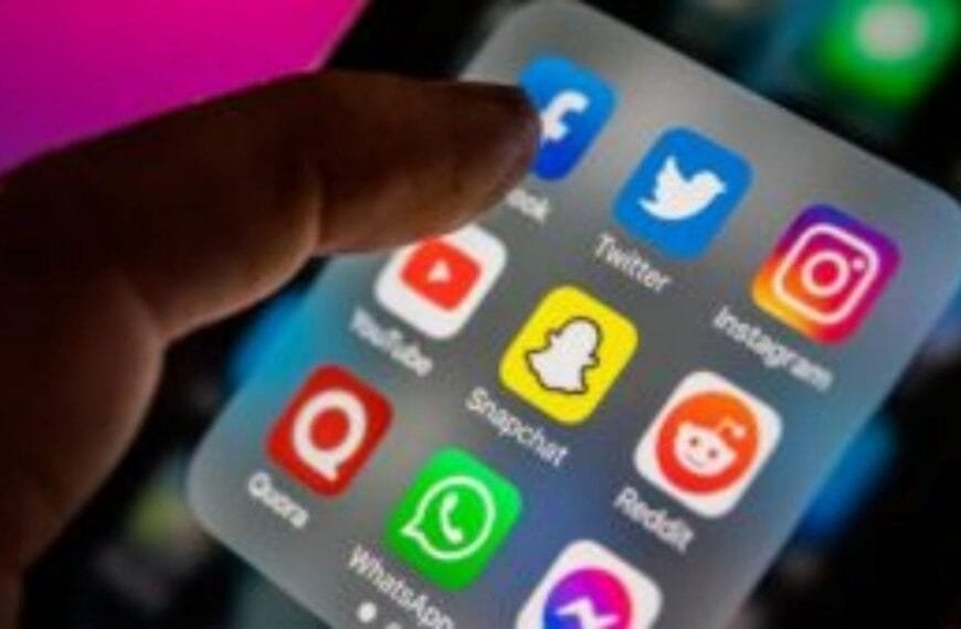 Policiais e a exposição em redes sociais-A imagem mostra a tela de um smartphone com ícones de aplicativos de redes sociais populares, como Facebook, Twitter, Instagram, YouTube, Snapchat, Reddit, Quora e WhatsApp, com um dedo prestes a tocar na tela.