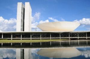 PEC24/2024: Prédio do Congresso Nacional, em Brasília, com as torres do Parlamento e a cúpula do Senado refletidas no espelho d'água